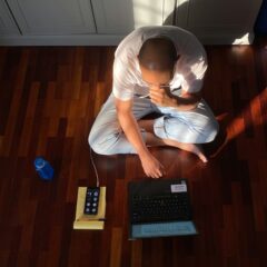 person sat on floor with laptop