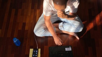 person sat on floor with laptop
