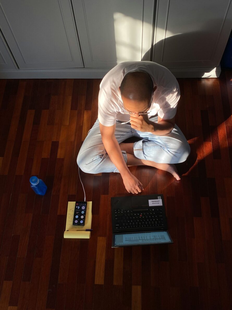 person sat on floor with laptop